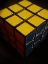Vertical shot of Rubik's cube isolated on a black background