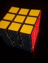 Vertical shot of Rubik's cube isolated on a black background