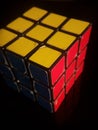 Vertical shot of Rubik\'s cube isolated on a black background