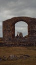 Vertical shot of ruins of an arch, Saint Dwynwen, Llanddwyn Island, Wales Royalty Free Stock Photo