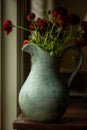 Vertical shot of a rustic vase of red roses Royalty Free Stock Photo