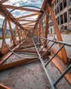 Vertical shot of a rusty crane ladder on a concrete surface Royalty Free Stock Photo