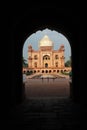 Vertical shot of the Safdarjung Tomb in New Delhi, India visible through the dark arch Royalty Free Stock Photo