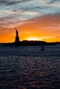 Vertical shot of sailboat in Hudson River in New York at Sunset and statue of Liberty silhouette Royalty Free Stock Photo