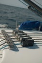 Vertical shot of a sailboat rope stopper on a white boat on the ocean