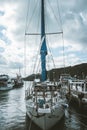 Vertical shot of a sailing boat at a harbor on a cloudy day Royalty Free Stock Photo