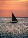 Vertical shot of a sailing boat in the sea during the sunset Royalty Free Stock Photo