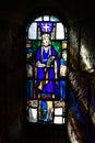 Vertical shot of Saint Margaret on a stained glass of a chapel