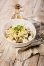 Vertical shot salad with squid rings, mozzarella cheese, olives, capers and microgreens in a white bowl. Mediterranean diet Royalty Free Stock Photo