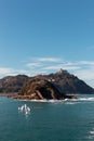 Vertical shot of Santa Clara Island in front of Mount Igueldo in Donostia, San Sebastian, Spain Royalty Free Stock Photo