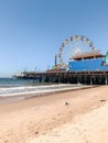 Vertical shot of the Santa Monica Pier with the Ferris wheel in the summertime