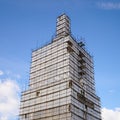 Scaffolding from planks around old bell tower. Concept of historical reenactment of repair work, access to elements of Royalty Free Stock Photo