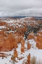 Vertical shot of the scenic stone formations covered in snow in Bryce Canyon, Utah Royalty Free Stock Photo