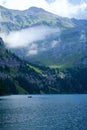 Vertical shot of a scenic view of Oeschinen Lake among the mountains in Kandersteg, Switzerland