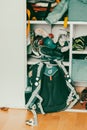 Vertical shot of a school backpack leaning against a open messy wardrobe