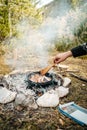 Vertical shot of scrambled egg on camp fire with trees in the background Royalty Free Stock Photo