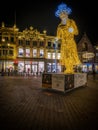 Vertical shot of the Scrooge light object on the main square of Deventer city at night