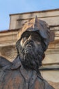 Vertical shot of a sculpture of a bearded man