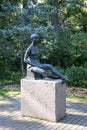 Vertical shot of a sculpture of a girl in Leo Mol Sculpture Garden in Winnipeg, Canada.