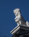 Vertical shot of a sculpture of a lion with human face on top of historical villa in Kielce, Poland