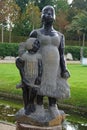 Vertical shot of a sculpture of mother and child at the Schwetzingen Palace garden in Germany