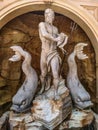 Vertical shot of a sculpture of Poseidon with dolphins in Epcot Studios, Orlando, FL, USA