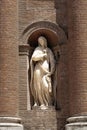 Vertical shot of a sculpture of saint Mary on a building