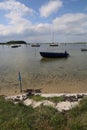 Vertical shot of the sea with boats on it under a blue cloudy sky in Drejet, Toro Huse, Denmark Royalty Free Stock Photo