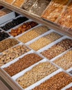 Vertical shot of a selection of dried nuts displayed on a market stall