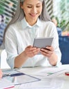 Vertical shot of senior business lady holding using tablet device in office.