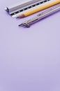 Vertical shot of a set of technical drawing tools on a purple background with a copy space Royalty Free Stock Photo