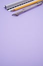 Vertical shot of a set of technical drawing tools on a purple background with a copy space Royalty Free Stock Photo