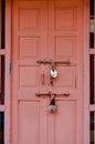 Vertical shot of a shabby pink wooden door with two old latches on,in Mandawa haveli,Rajasthan India Royalty Free Stock Photo