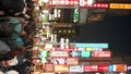 Vertical shot Shibuya street, luminous placards embellish the surroundings