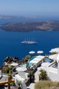 Vertical shot of a ship on the beautiful seascape near the Santorini island coastline in Greece