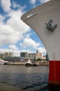 Vertical shot of a ship moored at a port of Hamburg, Germany against a cloudy blue sky Royalty Free Stock Photo