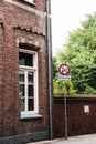 Vertical shot of a sign with crossed out alcohol, drugs, and marijuana by an old building