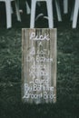 Vertical shot of signage, pick a seat either side on a wedding day with a blurred background.