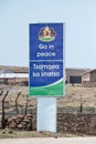 Vertical shot of the signboard "Go in peace" on the border between Lesotho and South Africa