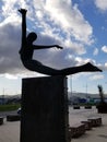 Vertical shot of the silhouette of a statue of a dancing girl