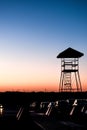 Vertical shot of a silhouette of a tower at a soft pink sunset