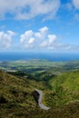 Vertical shot of single car in road trip. Top view of beautiful green valley in Sao Miguel island in the Azores, Portugal. Acores Royalty Free Stock Photo