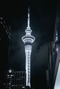 Vertical shot of the Sky Tower illuminated by lights at night in Auckland, New Zealand