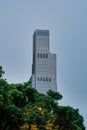 Vertical shot of a skyscraper and trees in Hong Kong, China