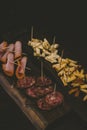 Vertical shot of sliced cheese and baloney on a wooden board Royalty Free Stock Photo