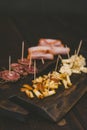 Vertical shot of sliced cheese and baloney on a wooden tray Royalty Free Stock Photo