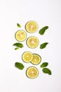 Vertical shot of slices of fresh lemon on a white surface Royalty Free Stock Photo