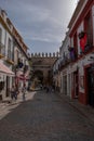 Vertical shot of a small beautiful street with people walking in Cordoba city, Andalusia, Spain