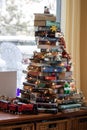 Vertical shot of a small Christmas tree made of books and Christmas lights