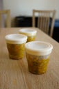 Vertical shot of small containers filled with baby food
